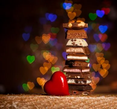 Chocolate stack on colorful bokeh background Stock Photos