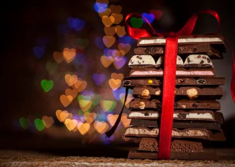 Chocolate stack on colorful bokeh background Stock Photos