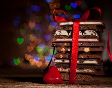 Chocolate stack on colorful bokeh background Stock Photos