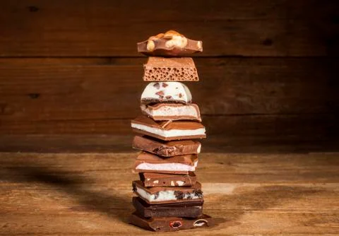 Chocolate stack on wooden background Stock Photos