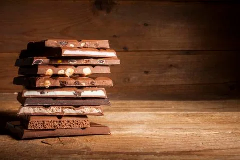 Chocolate stack on wooden background Stock Photos