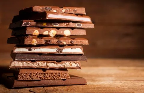 Chocolate stack on wooden background Stock Photos