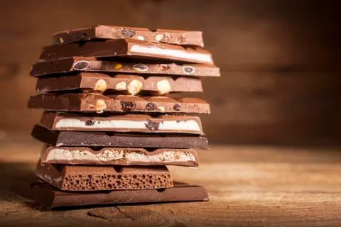 Chocolate stack on wooden background Stock Photos