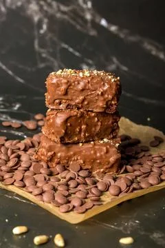 Chocolate sticks with peanuts on a dark background Stock Photos