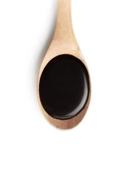 Chocolate syrup on a spoon Stock Photos
