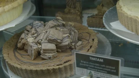 Chocolate Tart with Biscuit Topping in Cafe Display Case, Australia Editorial Stock Footage 345670587