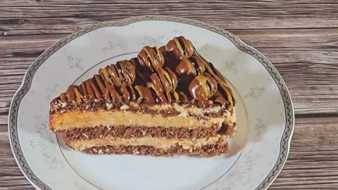 Chocolate triangular spongy cake piece filled and topped with chocolate Stock Footage 284937821