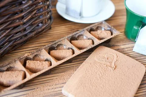 Chocolate truffles with cups of tea on the table. Stock Photos