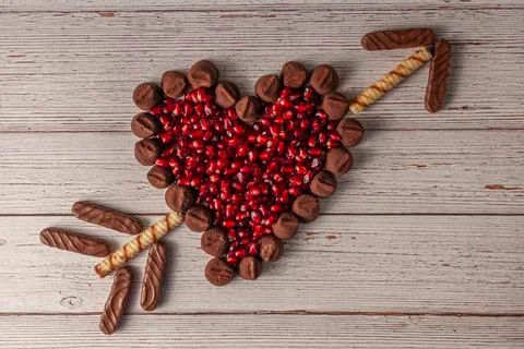 Chocolate truffles designed in heart shape and the filled with fresh pomegranate Stock Photos