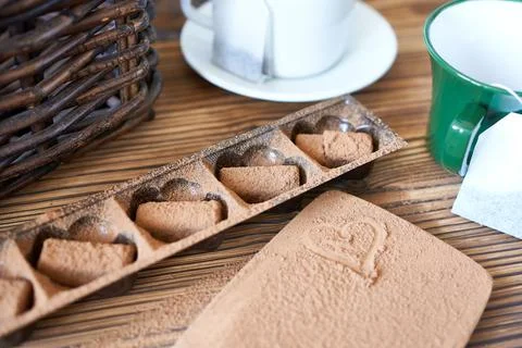 Chocolate truffles with two cups of tea. Stock Photos