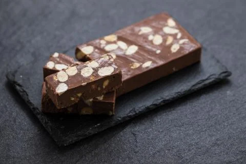 Chocolate turron on ceramic background Stock Photos
