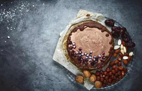 Chocolate vegan cake with different nuts, dates and carob Stock Photos
