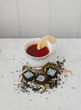 Chocolates and tea with lemon Stock Photos