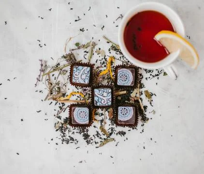 Chocolates and tea with lemon Stock Photos