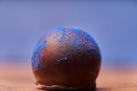 Chocolates with blue algae on blue background. Stock-Fotos
