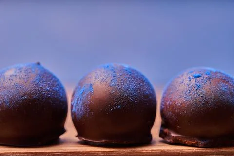 Chocolates with blue algae on blue background. Stock-Fotos