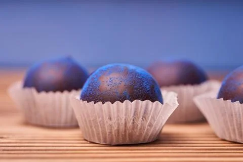 Chocolates with blue algae on wooden background. Foto stock