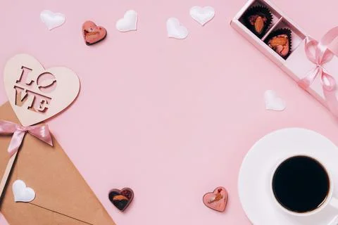 Chocolates festive box cup of coffee, hearts, an envelope pink background Stock Photos