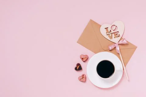 Chocolates festive box cup of coffee, hearts, an envelope pink background Stock Photos
