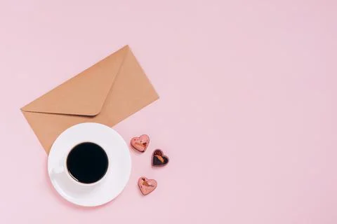Chocolates festive box cup of coffee, hearts, an envelope pink background Stock Photos