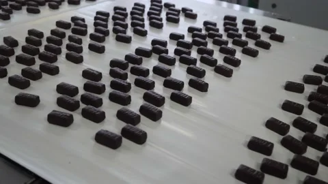 Chocolates moving along a conveyor line in a factory  Stock Footage 146161905