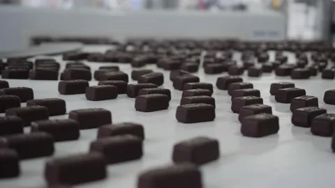 Chocolates moving along a conveyor line in a factory  Video stock 146161951