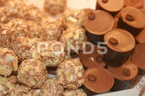 Chocolates with nuts. Texture of candy. Confectionery. Stock Photos