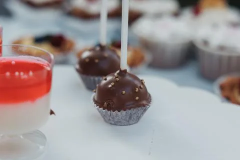 Chocolates sit delicately on a white surface Foto stock