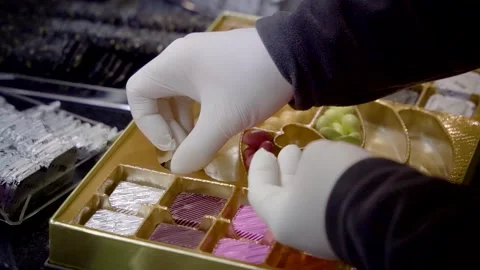 A chocolatier placing single special chocolates inside a chocolate box 스톡 동영상 278489710