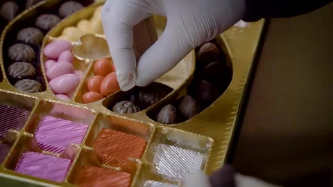A chocolatier placing single special chocolates inside a chocolate box 스톡 동영상 278489957