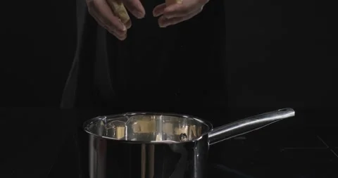 Chocolatier pours white chocolate into a pan to melt it. Cooking handmade Stock Footage 250813352