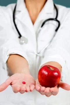 Choice between apple and pill. Фото