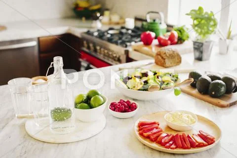 A choice of prepared fresh salads on a kitchen counter. Stock Photos