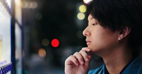 Choice, vending machine and thinking with Japanese man in city for food decision Stock Photos