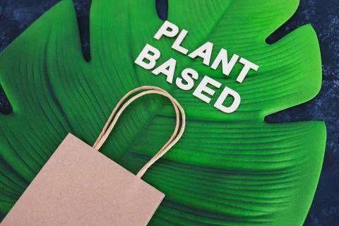 Choices for the environment, plant-based text with shopping bag on big tropic Stock Photos