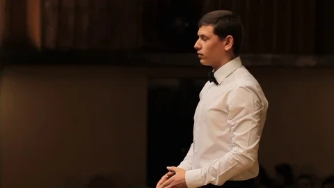 Choir conductor during performance Stock Footage 77728387