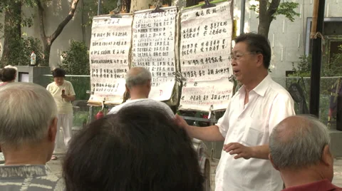 Choirmaster leads sining in park Stock Footage 37703973