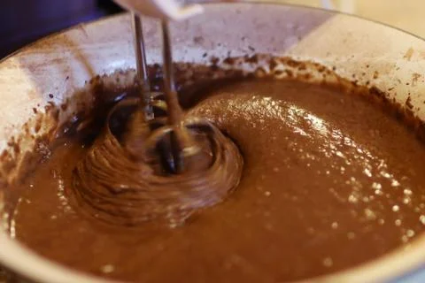 Chokolate dough for cake in cooking process with mixer in bowl Stock Photos