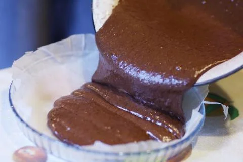 Chokolate dough for cake in cooking process with mixer in bowl Stock Photos