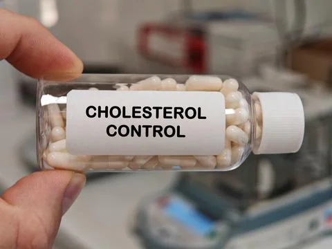 CHOLESTEROL CONTROL hard capsule supplement concept for nutrition wellness Stock Photos