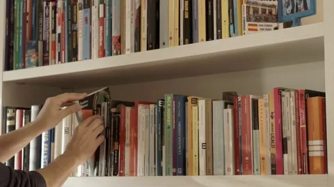 Choose  a book from bookshelf Stock Footage 44830409
