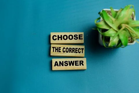 Choose the correct answer text stacked wooden cubes on the table. Stock Photos