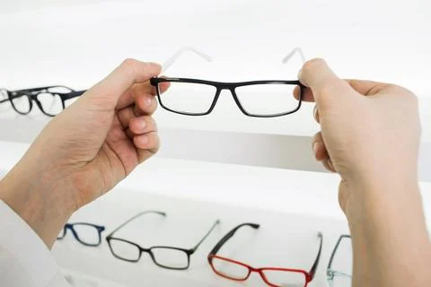 Choose glasses in the store optics Stock Photos