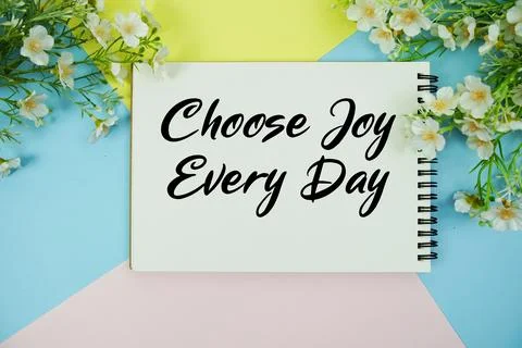 Choose Joy Every Day text written on notepad with flowers decorations flat .. Stock Photos