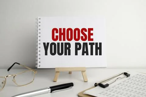 CHOOSE YOUR PATH, text on white paper on the light background with charts pap Stock Photos
