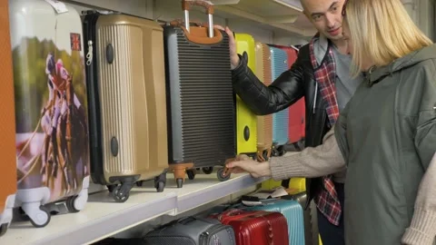 Chooses a suitcase in a supermarket Stock Footage 133232952