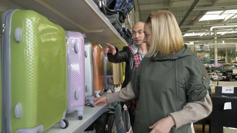 Chooses a suitcase in a supermarket Stock Footage 133234774