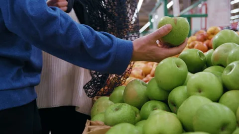 Choosing Apples Together and Using Reusable Bag Stock Footage 330954202