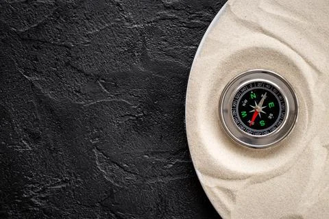 Choosing best solution with compass in the sand Stock Photos