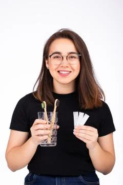 Choosing between brushing your teeth and chewing gum concept. Woman offering to Stock Photos